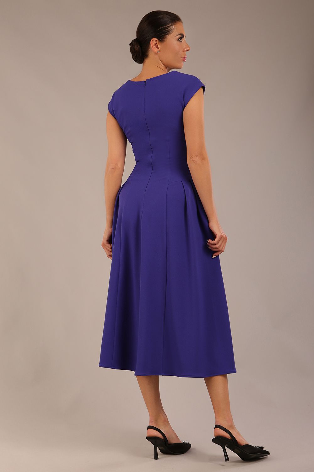 brunette model is wearing a diva catwalk Audrey a-line Dress sweetheart neckline and With Pockets and sleeveless with ankle length in spectrum indigo colour back
