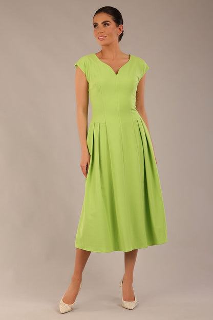 brunette model is wearing a diva catwalk Audrey a-line Dress sweetheart neckline and With Pockets and sleeveless with ankle length in lime green colour