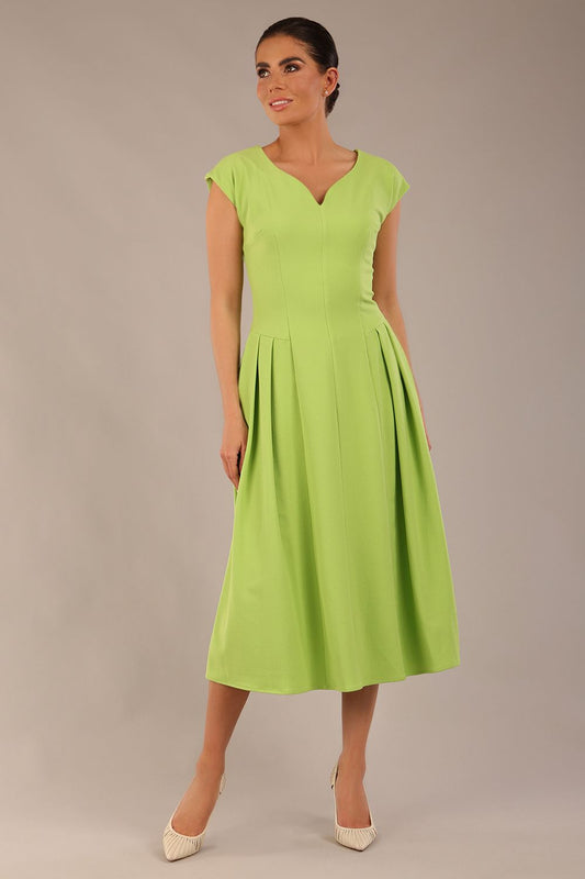 brunette model is wearing a diva catwalk Audrey a-line Dress sweetheart neckline and With Pockets and sleeveless with ankle length in lime green colour