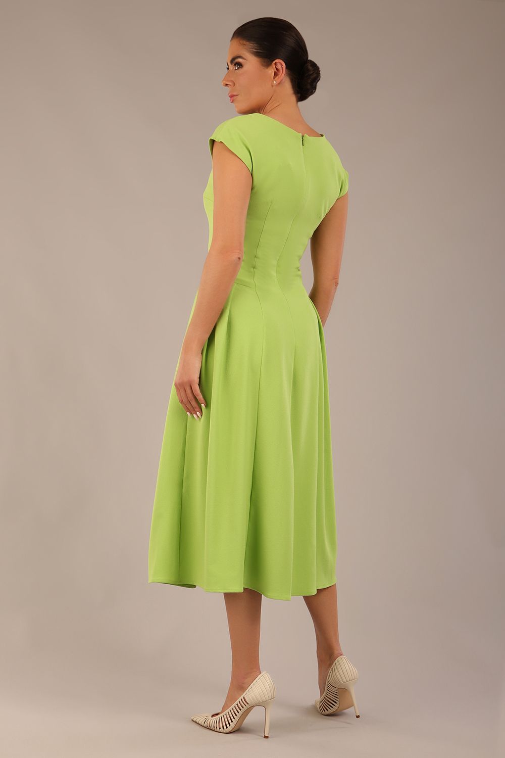 brunette model is wearing a diva catwalk Audrey a-line Dress sweetheart neckline and With Pockets and sleeveless with ankle length in lime green colour