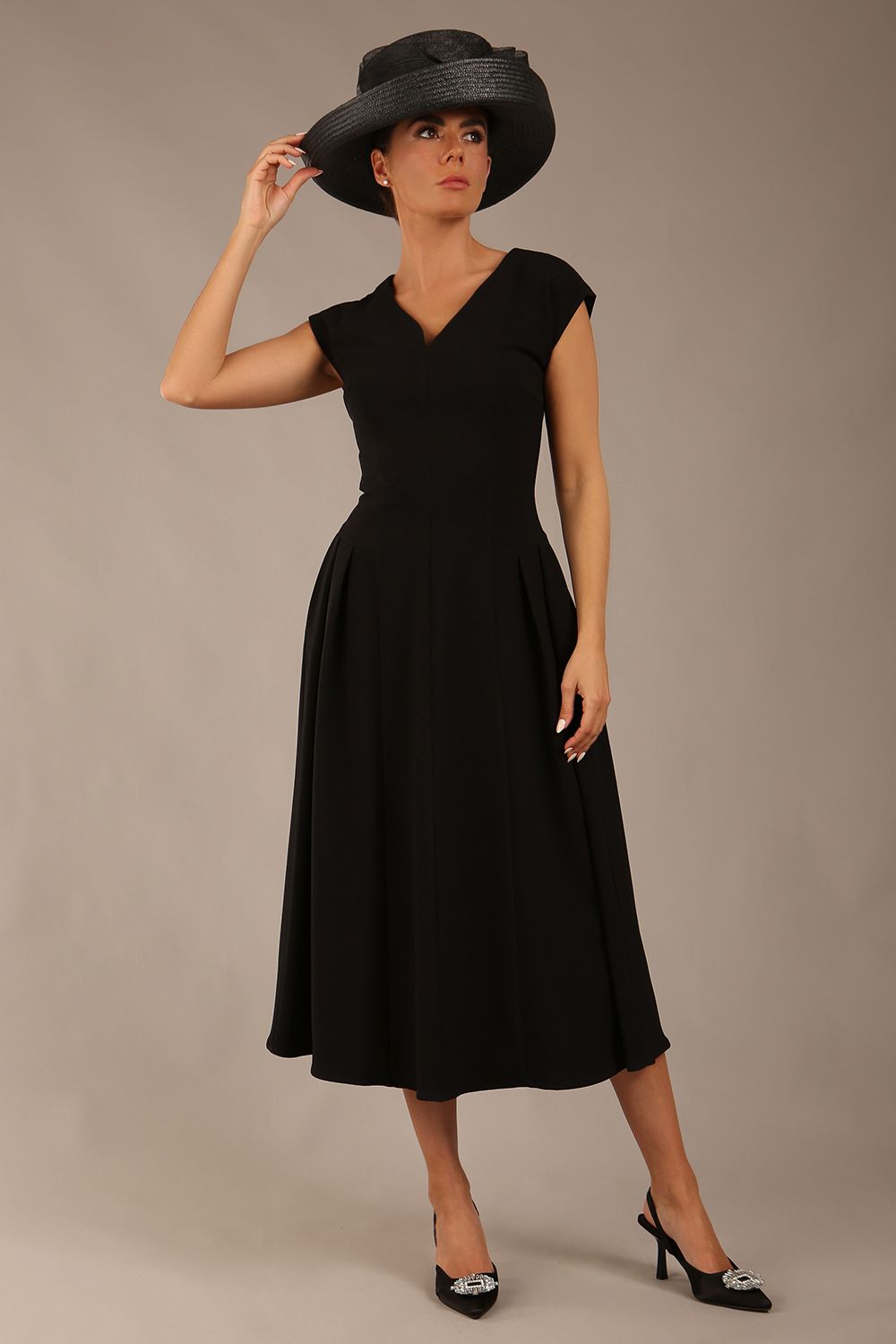 brunette model is wearing a diva catwalk Audrey a-line Dress sweetheart neckline and With Pockets and sleeveless with ankle length black colour back