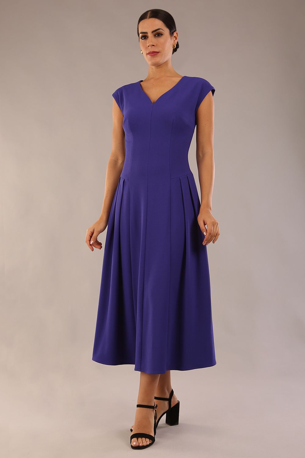 brunette model is wearing a diva catwalk Audrey a-line Dress sweetheart neckline and With Pockets and sleeveless with ankle length in spectrum indigo colour back