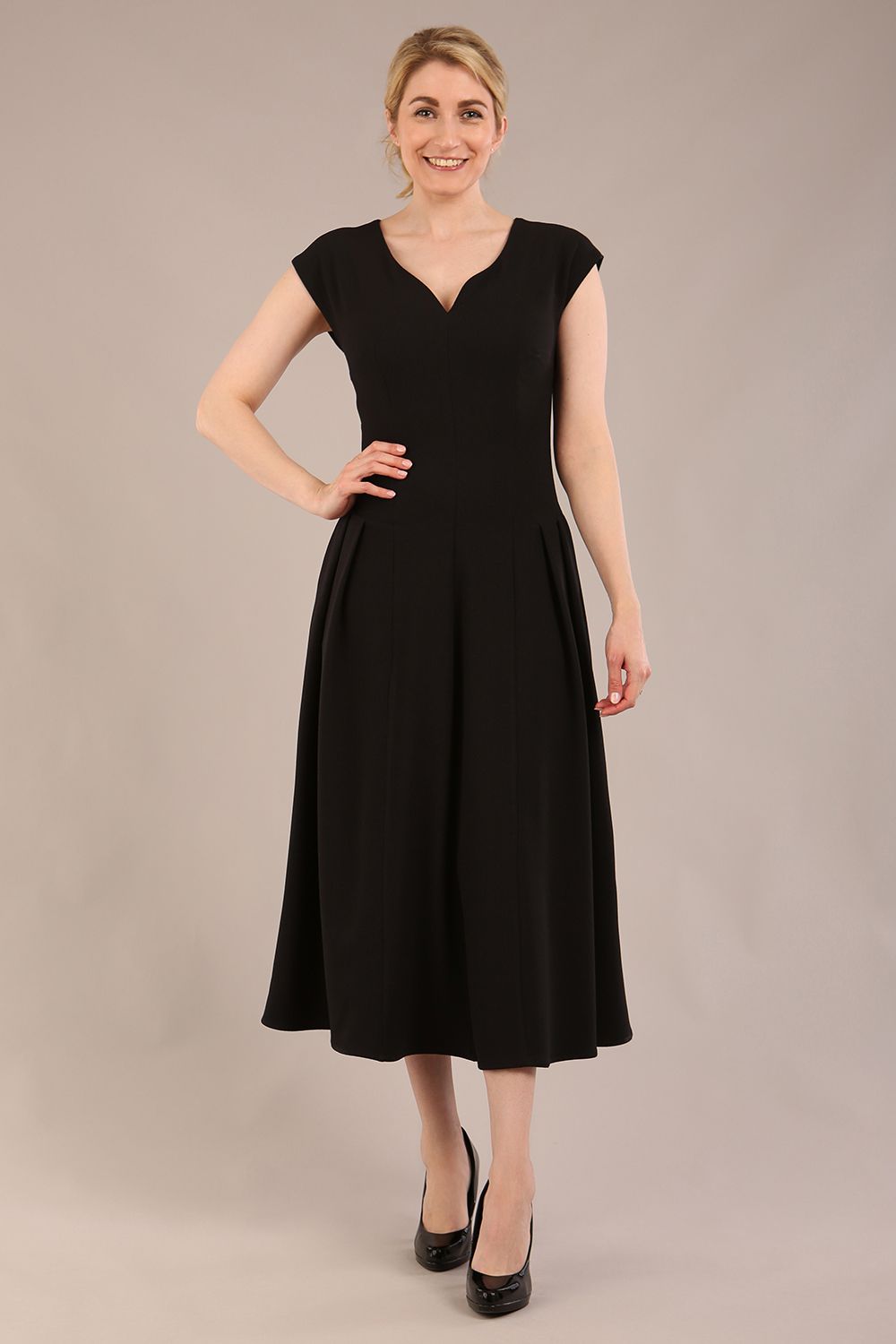 brunette model is wearing a diva catwalk Audrey a-line Dress sweetheart neckline and With Pockets and sleeveless with ankle length black colour back