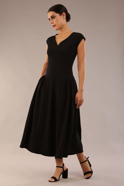 brunette model is wearing a diva catwalk Audrey a-line Dress sweetheart neckline and With Pockets and sleeveless with ankle length black colour back
