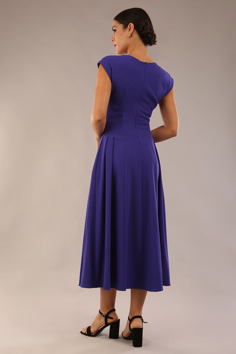 brunette model is wearing a diva catwalk Audrey a-line Dress sweetheart neckline and With Pockets and sleeveless with ankle length in spectrum indigo colour back