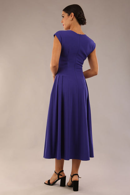 brunette model is wearing a diva catwalk Audrey a-line Dress sweetheart neckline and With Pockets and sleeveless with ankle length in spectrum indigo colour back