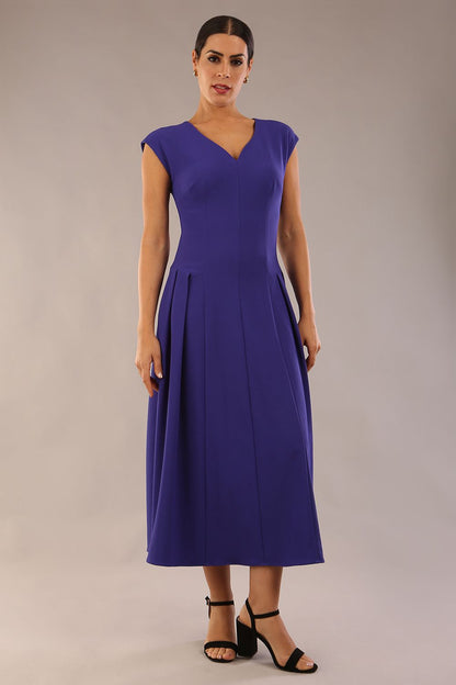 brunette model is wearing a diva catwalk Audrey a-line Dress sweetheart neckline and With Pockets and sleeveless with ankle length in spectrum indigo colour back