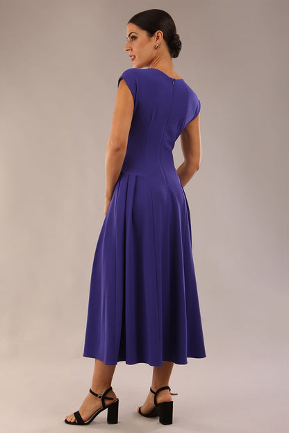brunette model is wearing a diva catwalk Audrey a-line Dress sweetheart neckline and With Pockets and sleeveless with ankle length in spectrum indigo colour back