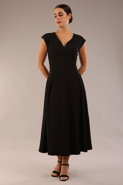 brunette model is wearing a diva catwalk Audrey a-line Dress sweetheart neckline and With Pockets and sleeveless with ankle length black colour back