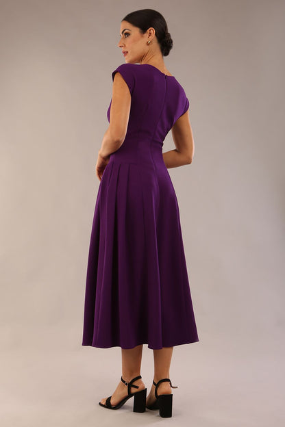 brunette model is wearing a diva catwalk Audrey a-line Dress sweetheart neckline and With Pockets and sleeveless with ankle length in passion purple colour back