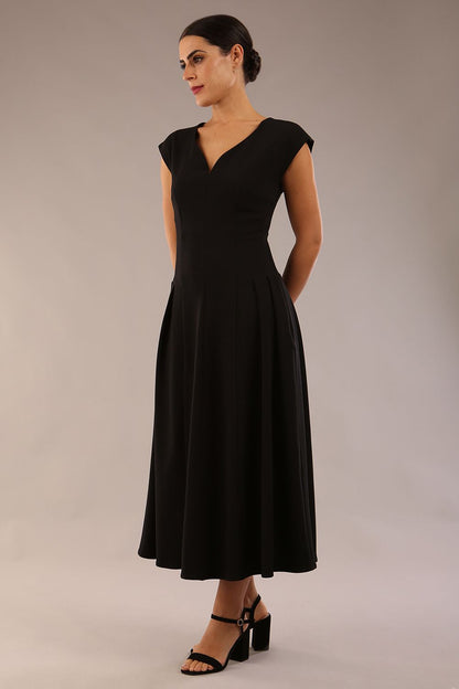 brunette model is wearing a diva catwalk Audrey a-line Dress sweetheart neckline and With Pockets and sleeveless with ankle length black colour back
