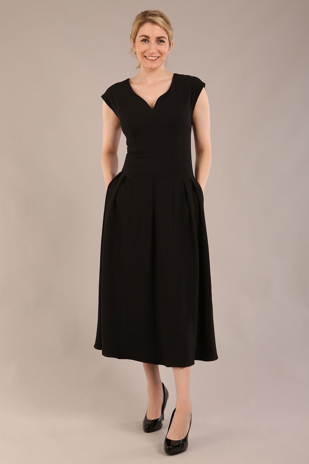 brunette model is wearing a diva catwalk Audrey a-line Dress sweetheart neckline and With Pockets and sleeveless with ankle length black colour back