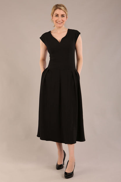 brunette model is wearing a diva catwalk Audrey a-line Dress sweetheart neckline and With Pockets and sleeveless with ankle length black colour back