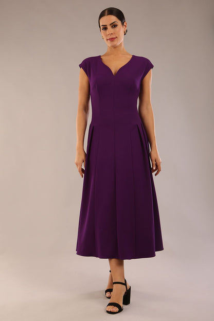 brunette model is wearing a diva catwalk Audrey a-line Dress sweetheart neckline and With Pockets and sleeveless with ankle length in passion purple colour back