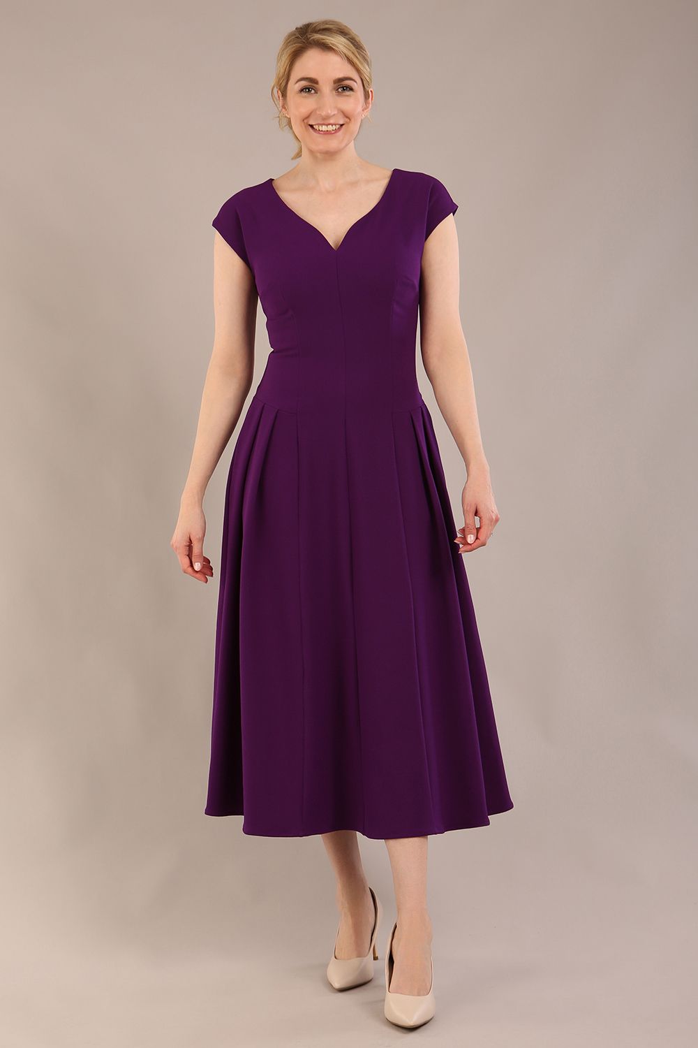 brunette model is wearing a diva catwalk Audrey a-line Dress sweetheart neckline and With Pockets and sleeveless with ankle length in passion purple colour back
