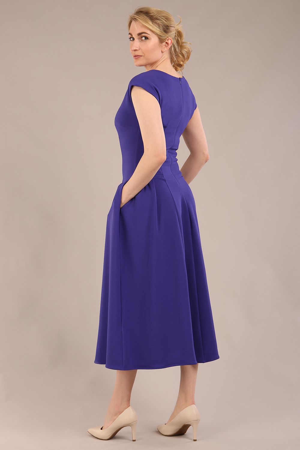 brunette model is wearing a diva catwalk Audrey a-line Dress sweetheart neckline and With Pockets and sleeveless with ankle length in spectrum indigo colour back