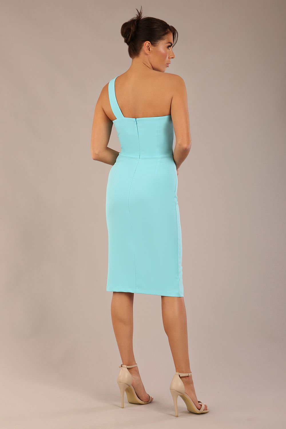 Model wearing a divacatwalk Sofia Pencil Dress knee length front side vent with diagonal halter neck in turquoise colour front