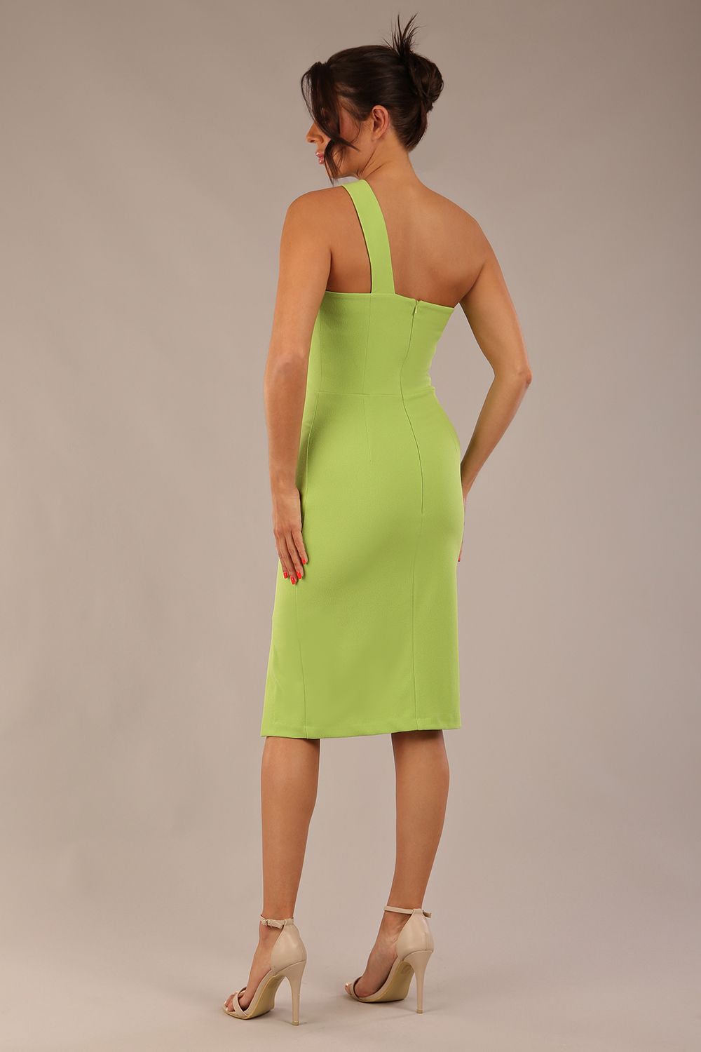Model wearing a divacatwalk Sofia Pencil Dress knee length front side vent with diagonal halter neck in lime green front
