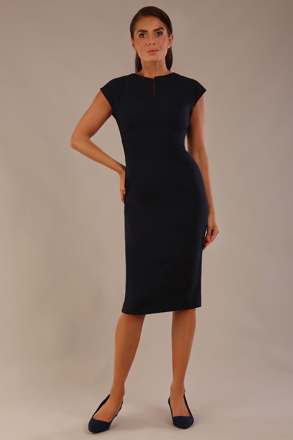 brunette model is wearing a diva catwalk Claire Cap Sleeve Pencil Dress cap sleeve with round neckline with v-slit and knee length indark navy colour front (Dark Navy)