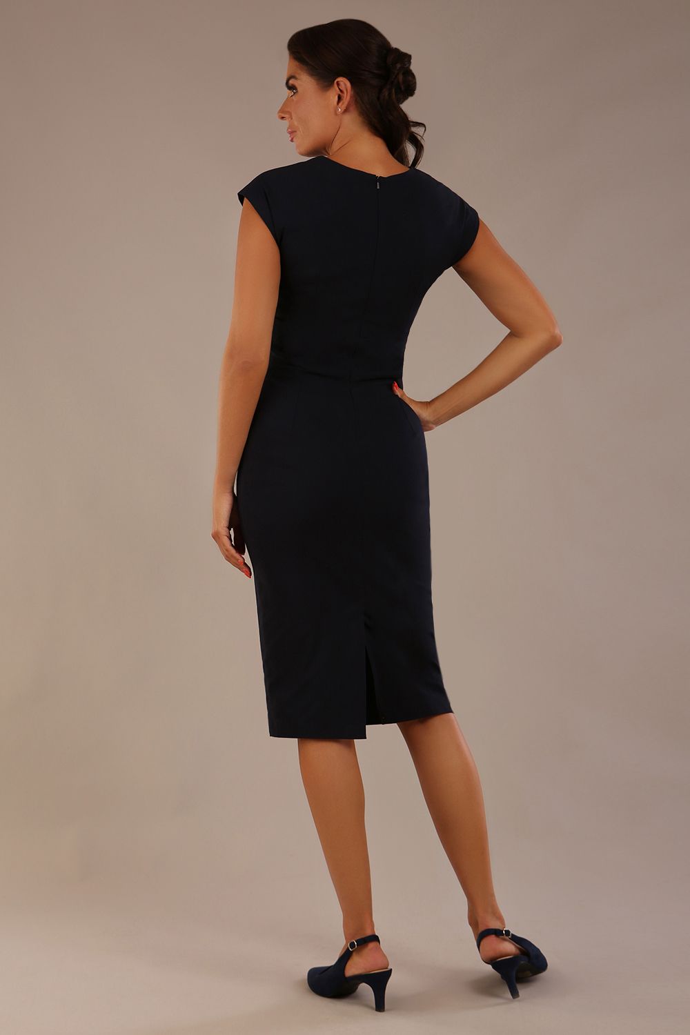 brunette model is wearing a diva catwalk Claire Cap Sleeve Pencil Dress cap sleeve with round neckline with v-slit and knee length indark navy colour back (Dark Navy)