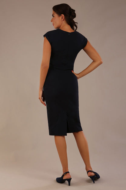 brunette model is wearing a diva catwalk Claire Cap Sleeve Pencil Dress cap sleeve with round neckline with v-slit and knee length indark navy colour back (Dark Navy)