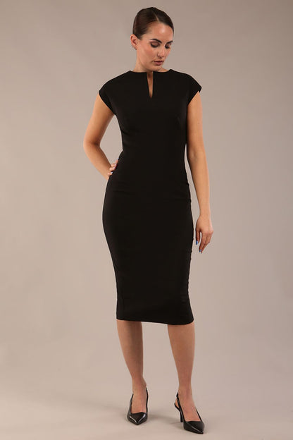 brunette model is wearing a diva catwalk Claire Cap Sleeve Pencil Dress cap sleeve with round neckline with v-slit and knee length in black colour front (Black)