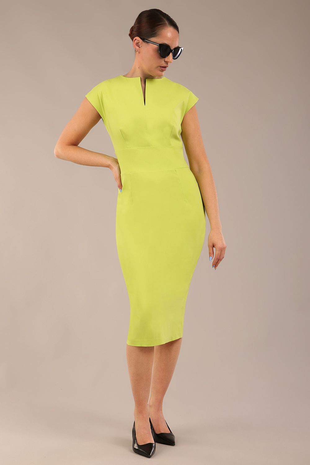 brunette model is wearing a diva catwalk Claire Cap Sleeve Pencil Dress cap sleeve with round neckline with v-slit and knee length in lime green colour front (Lime Green)