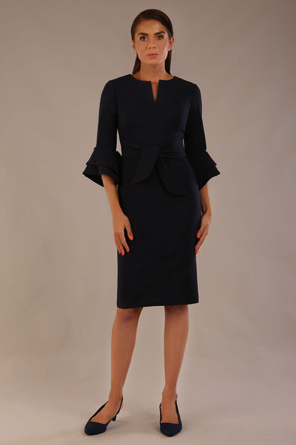 brunette model is wearing a diva catwalk Hobson ruffled sleeves Pencil Dress with tie waistband knee length in Dark Navy colour front (Dark Navy)