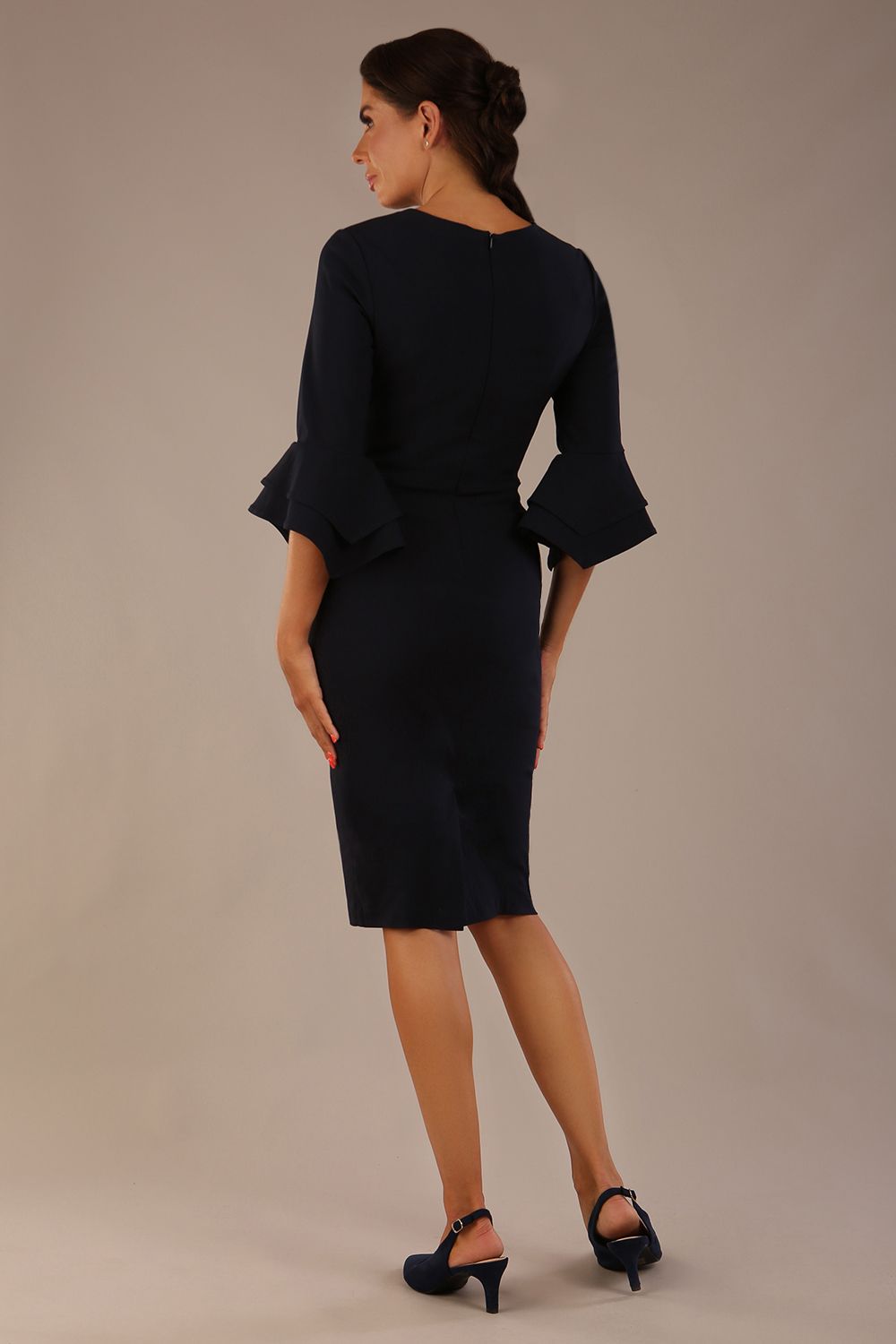 brunette model is wearing a diva catwalk Hobson ruffled sleeves Pencil Dress with tie waistband knee length in Dark Navy colour front (Dark Navy)