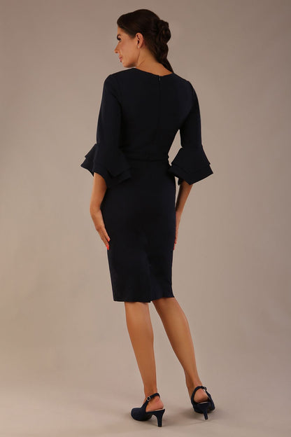 brunette model is wearing a diva catwalk Hobson ruffled sleeves Pencil Dress with tie waistband knee length in Dark Navy colour front (Dark Navy)