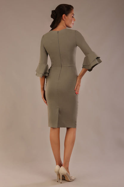 brunette model is wearing a diva catwalk Hobson ruffled sleeves Pencil Dress with tie waistband knee length in Castlerock Grey colour front (Castlerock Grey)