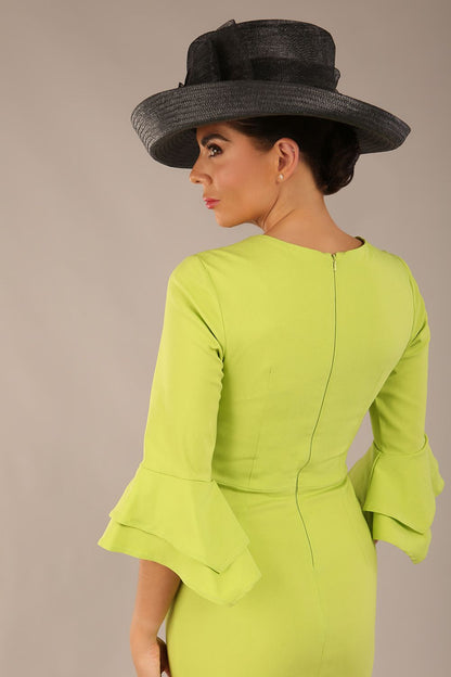 A model wearing a pink knee-length pencil dress with ruffled sleeves and a waist belt, standing against a plain background (Lime Green)