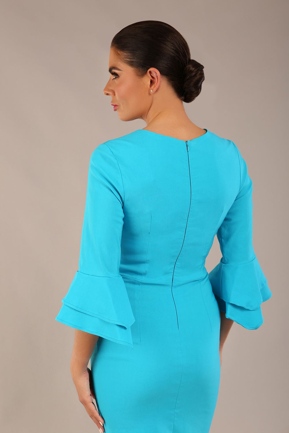 brunette model is wearing a diva catwalk Hobson ruffled sleeves Pencil Dress with tie waistband knee length in Azure Blue colour front (Azure Blue)
