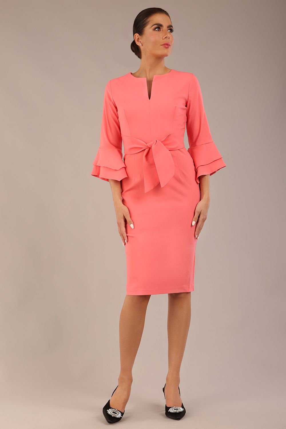 brunette model is wearing a diva catwalk Hobson ruffled sleeves Pencil Dress with tie waistband knee length in Dahlia Pink colour front (Dahlia Pink)