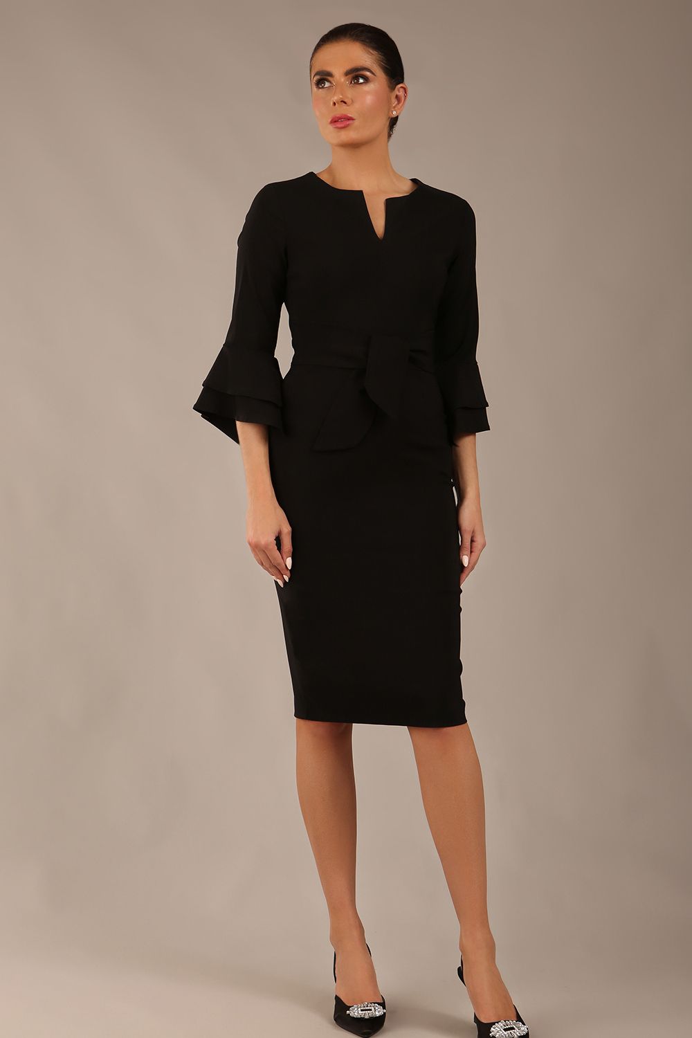 brunette model is wearing a diva catwalk Hobson ruffled sleeves Pencil Dress with tie waistband knee length in Black colour front (Black)