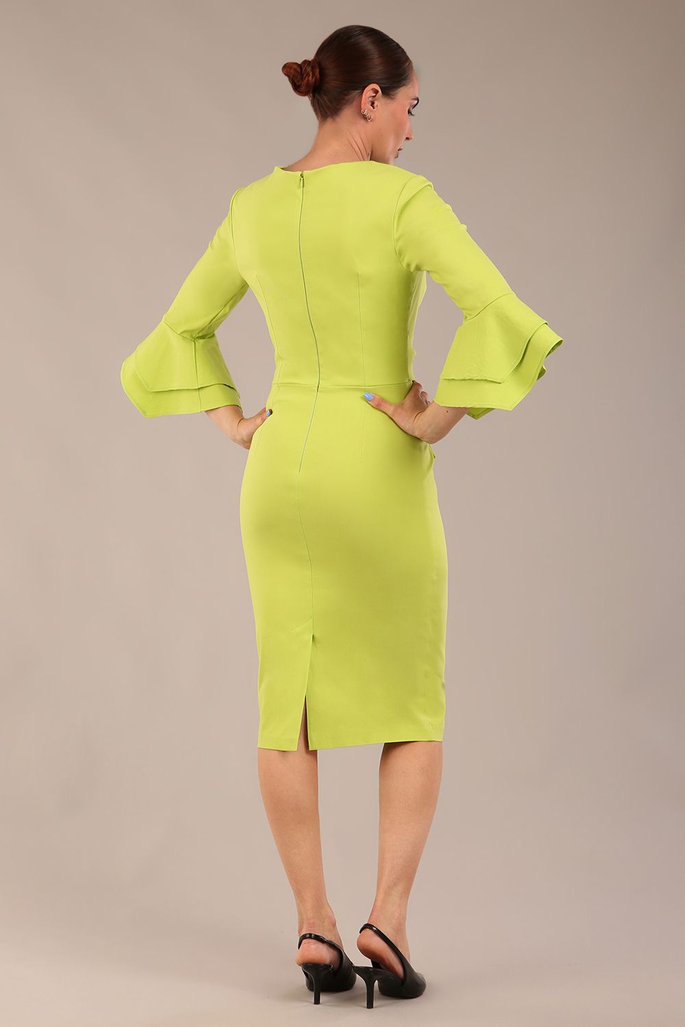A model wearing a pink knee-length pencil dress with ruffled sleeves and a waist belt, standing against a plain background (Lime Green)
