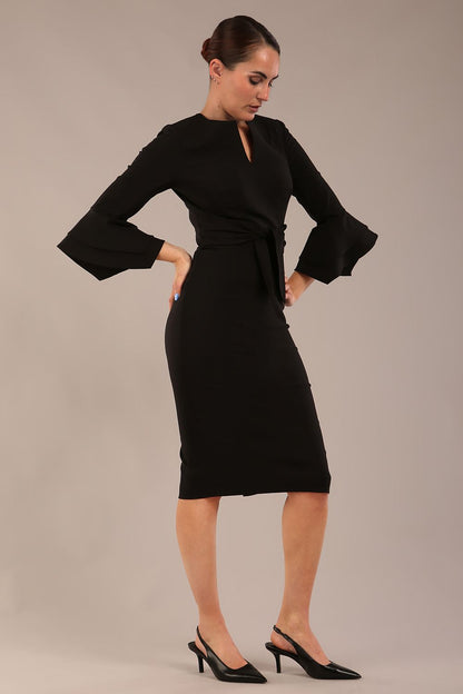 brunette model is wearing a diva catwalk Hobson ruffled sleeves Pencil Dress with tie waistband knee length in Black colour front (Black)