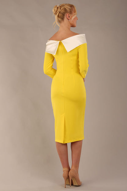 brunette Model is wearing a Rosalind Off Shoulder Bow Detail Pencil Dress 3/4 sleeve in Blazing Yellow / Ivory cream contrast front image (Blazing Yellow / Ivory)