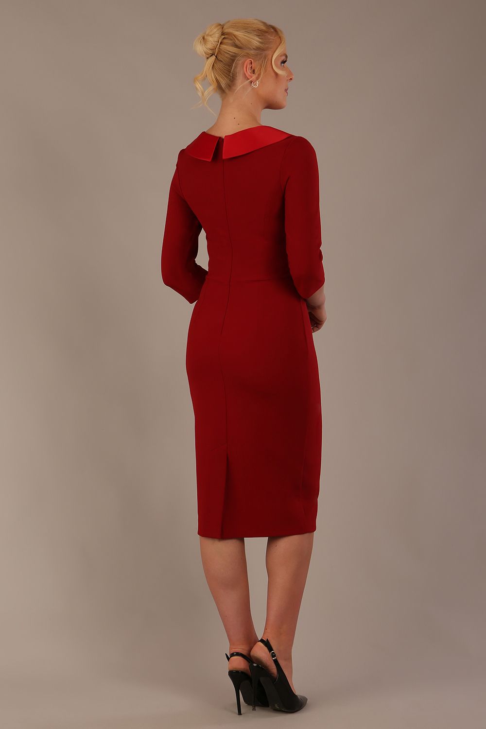 Woman wearing a Heathcote Floral Detail Pencil Dress with a plain background in rosewood red close up view