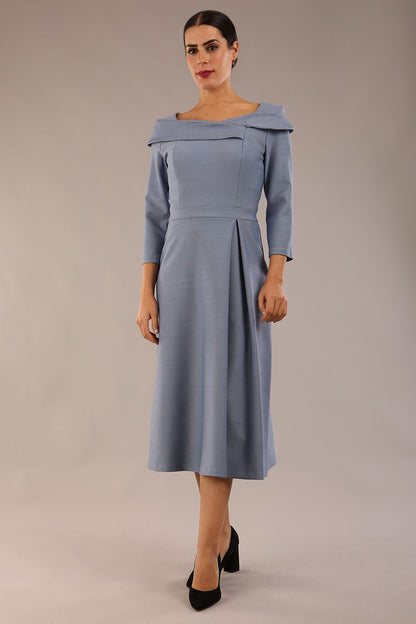 A model wearing a diva catwalk SEED Chrysanta sculptural collar dress 3/4 sleeve A-line dress with a round neckline and concealed zip at the back (Steel Blue)