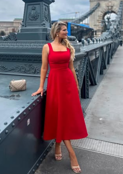 woman wearing a diva catwalk Tamsin Square Neckline Swing Dress sleeveless style with a midaxi  length and side pockets in Scarlet Red colour in Budapest (Scarlet Red)
