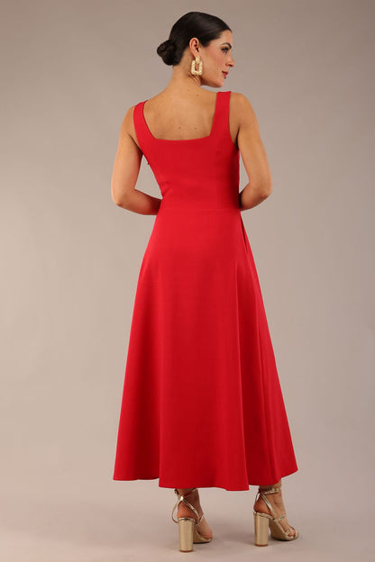 woman wearing a diva catwalk Tamsin Square Neckline Swing Dress sleeveless style with a midaxi  length and side pockets in Scarlet Red colour in Budapest (Scarlet Red)