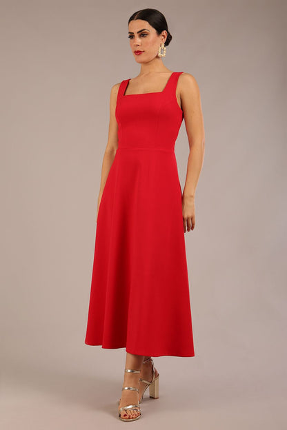 woman wearing a diva catwalk Tamsin Square Neckline Swing Dress sleeveless style with a midaxi  length and side pockets in Scarlet Red colour in Budapest (Scarlet Red)