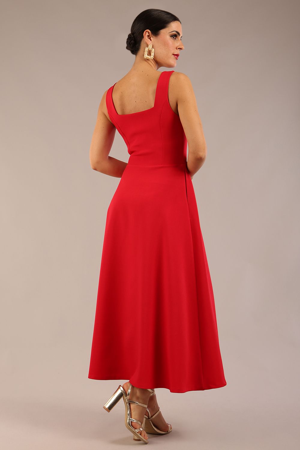 woman wearing a diva catwalk Tamsin Square Neckline Swing Dress sleeveless style with a midaxi  length and side pockets in Scarlet Red colour in Budapest (Scarlet Red)