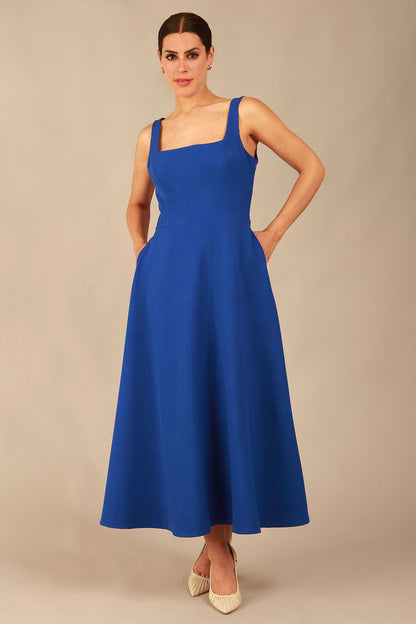 model wearing a diva catwalk Tamsin Square Neckline Swing Dress sleeveless style with a midaxi  length and side pockets in cobalt blue colour (Cobalt blue)