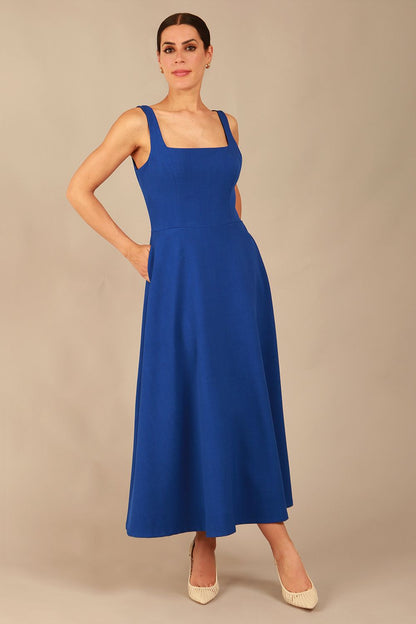 model wearing a diva catwalk Tamsin Square Neckline Swing Dress sleeveless style with a midaxi  length and side pockets in cobalt blue colour (Cobalt blue)