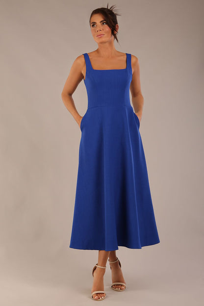model wearing a diva catwalk Tamsin Square Neckline Swing Dress sleeveless style with a midaxi  length and side pockets in cobalt blue colour (Cobalt blue)
