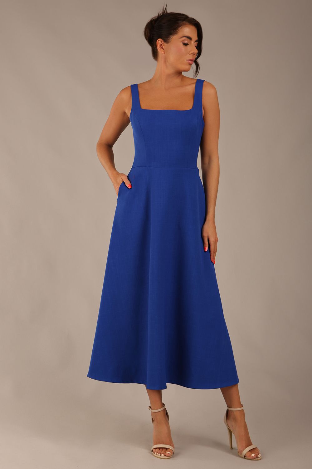 model wearing a diva catwalk Tamsin Square Neckline Swing Dress sleeveless style with a midaxi  length and side pockets in cobalt blue colour (Cobalt blue)