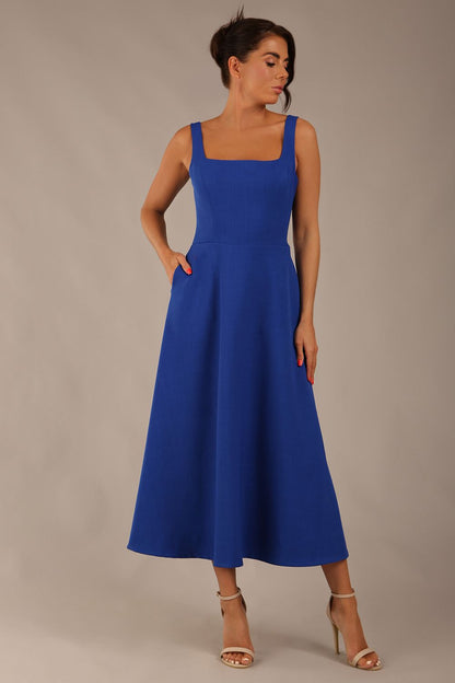 model wearing a diva catwalk Tamsin Square Neckline Swing Dress sleeveless style with a midaxi  length and side pockets in cobalt blue colour (Cobalt blue)