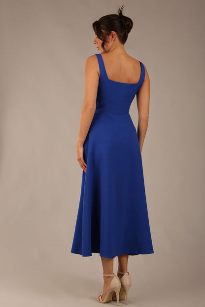 model wearing a diva catwalk Tamsin Square Neckline Swing Dress sleeveless style with a midaxi  length and side pockets in cobalt blue colour (Cobalt blue)
